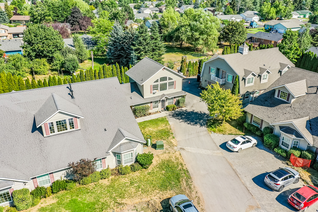 Aerial view of community surrounding by grass and trees