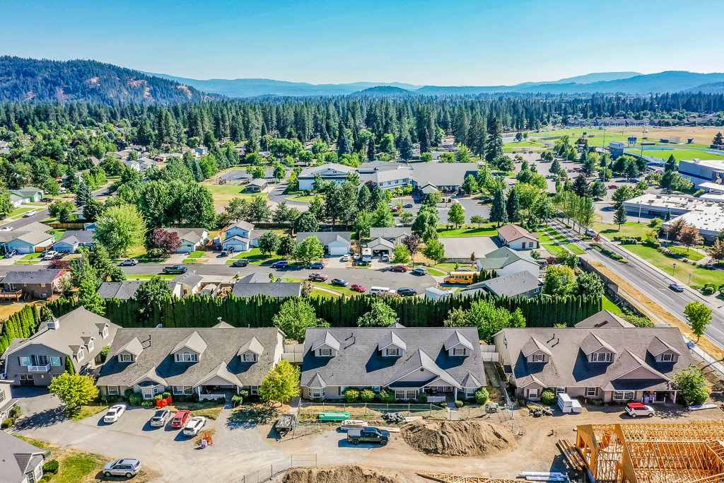 Aerial view of community surrounding by grass and trees